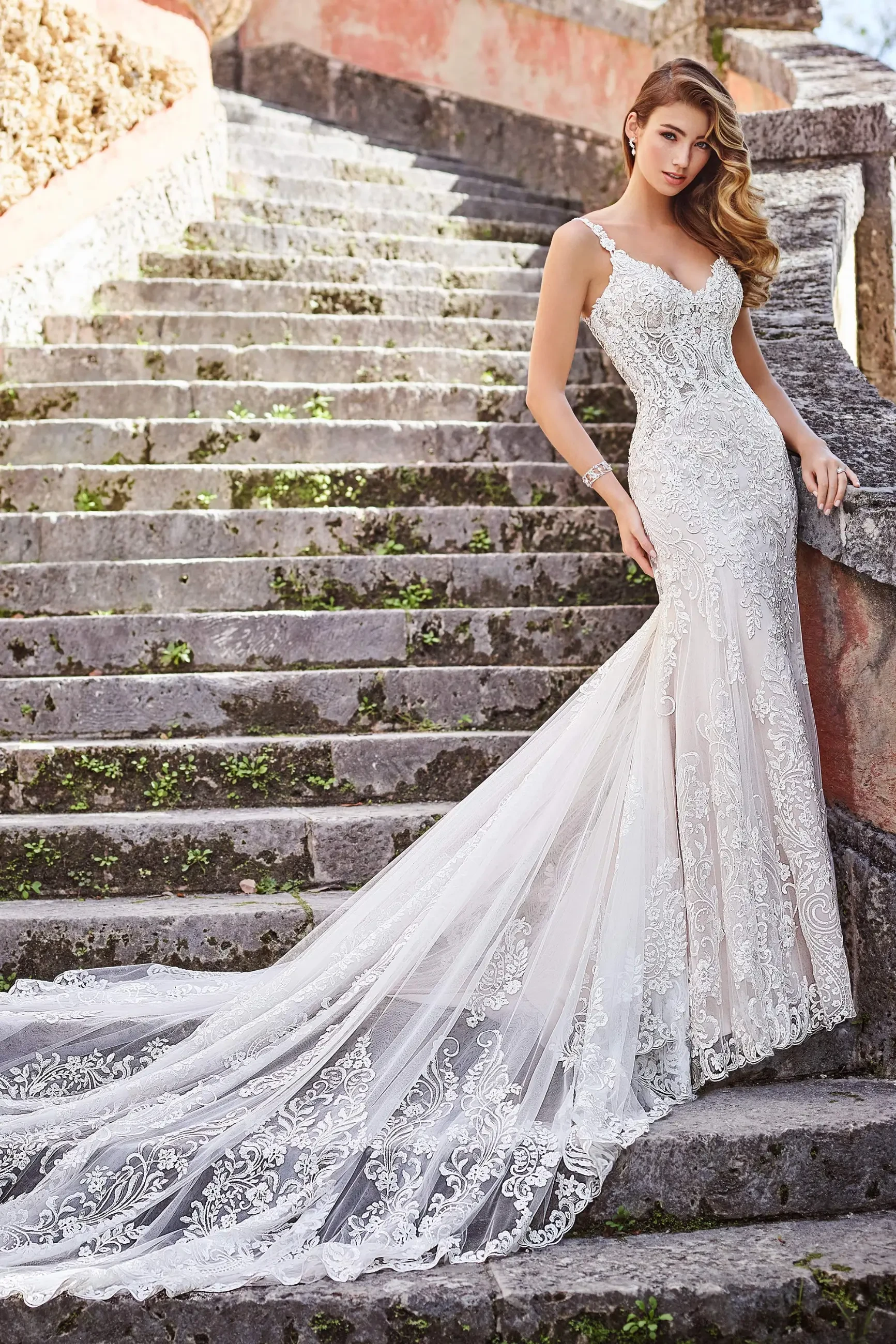 model is wearing a sleeveless lace fit and flare bridal gown