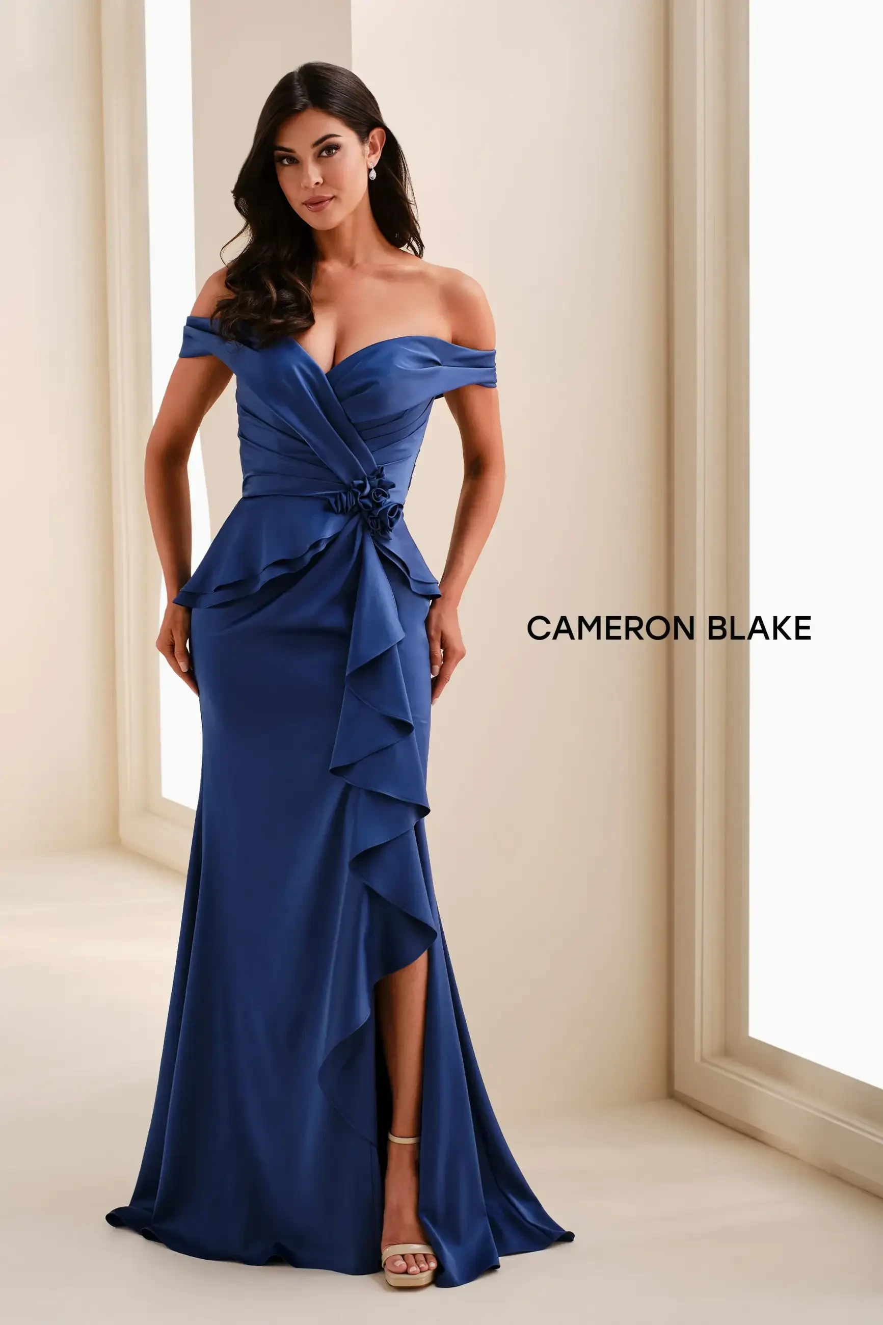model is wearing an off the shoulder blue mothers dress