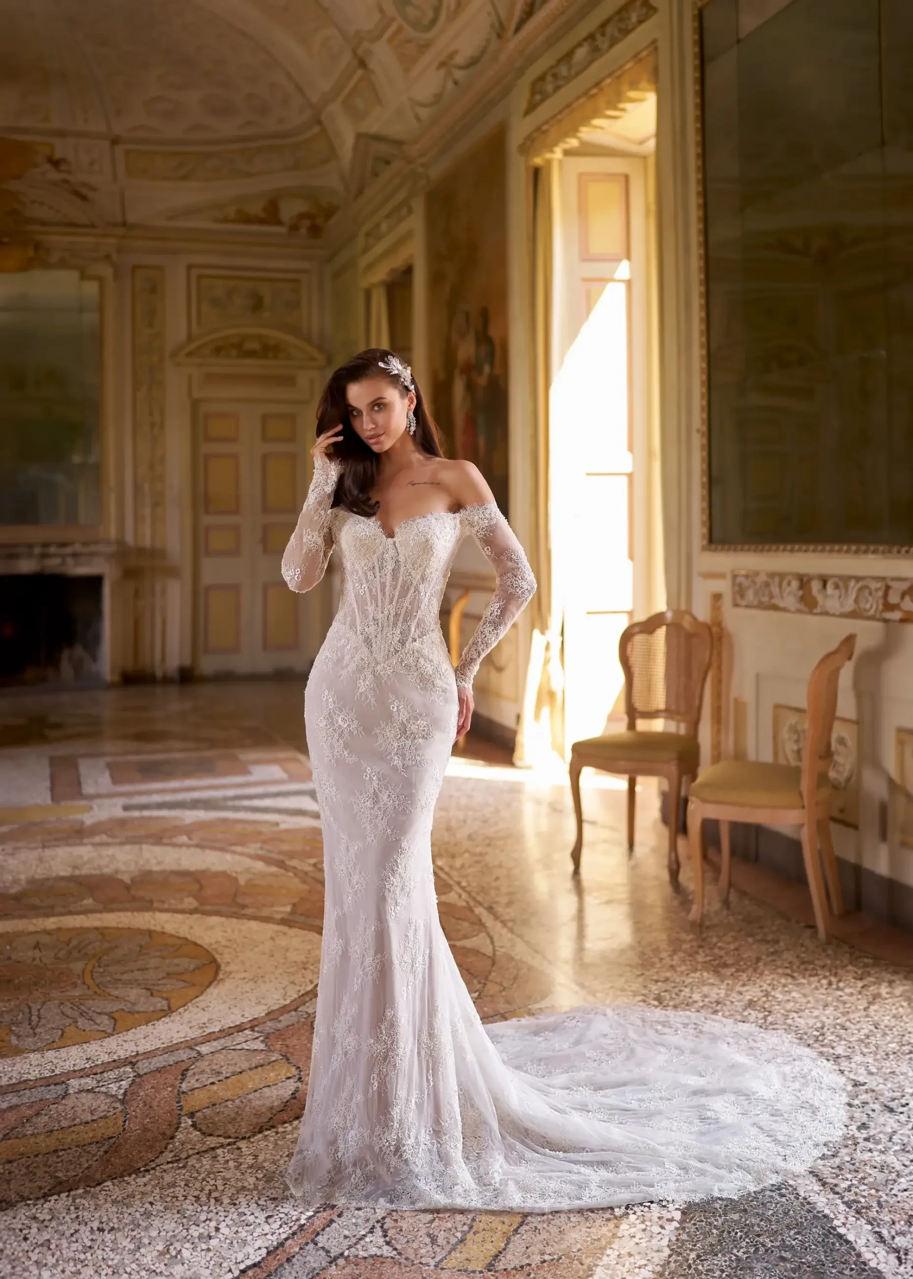 model is wearing a long sleeve lace fit and flare bridal gown